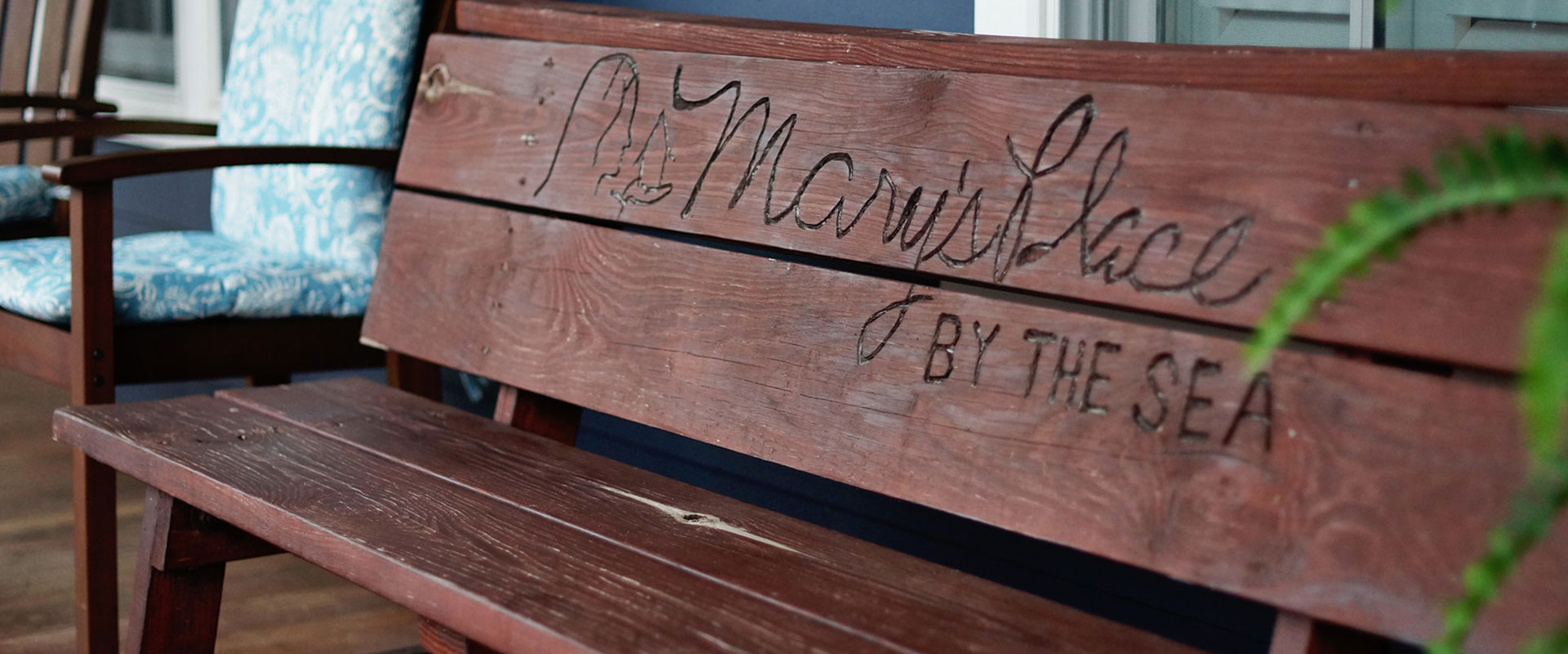 Porch bench with Mary's Place by the Sea inscribed on it