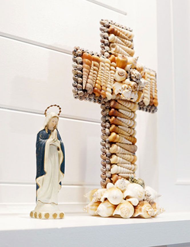 Mary statue and shell cross on mantle
