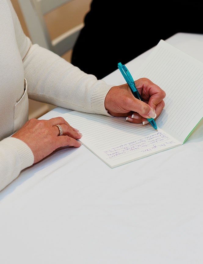 women writing in journal