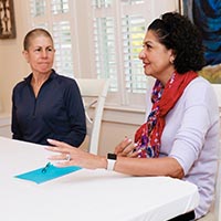 Two women talking at table