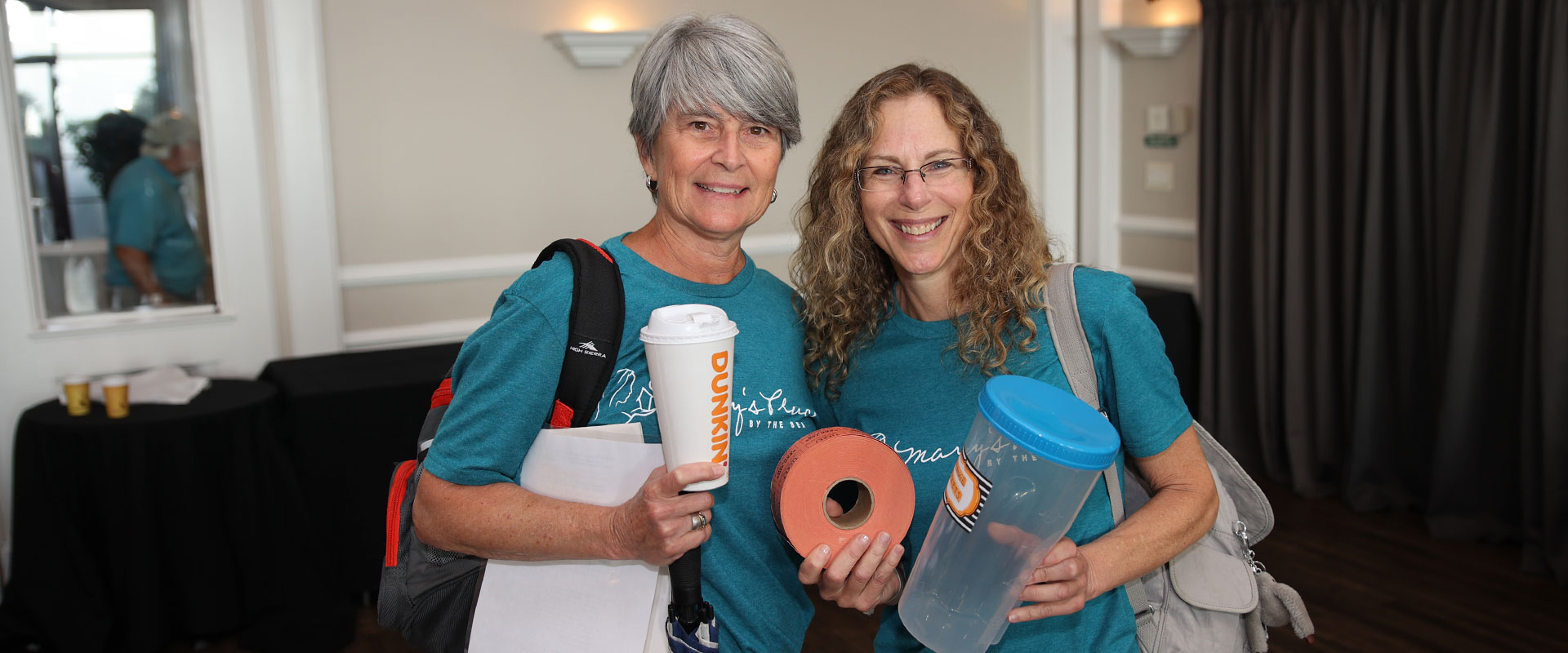 Women holding tickets for an event